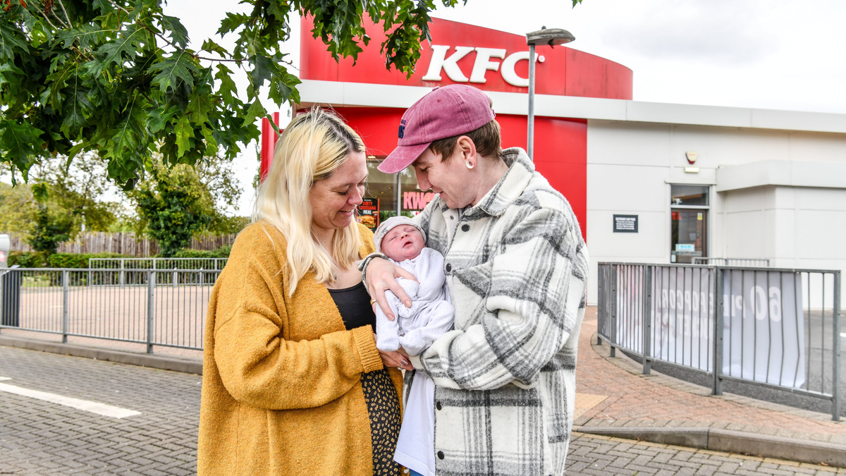 Katie Murphy holds newborn son Cody in a parking lot at a KFC car park in Bromsgrove, a town in Worcestershire, England.