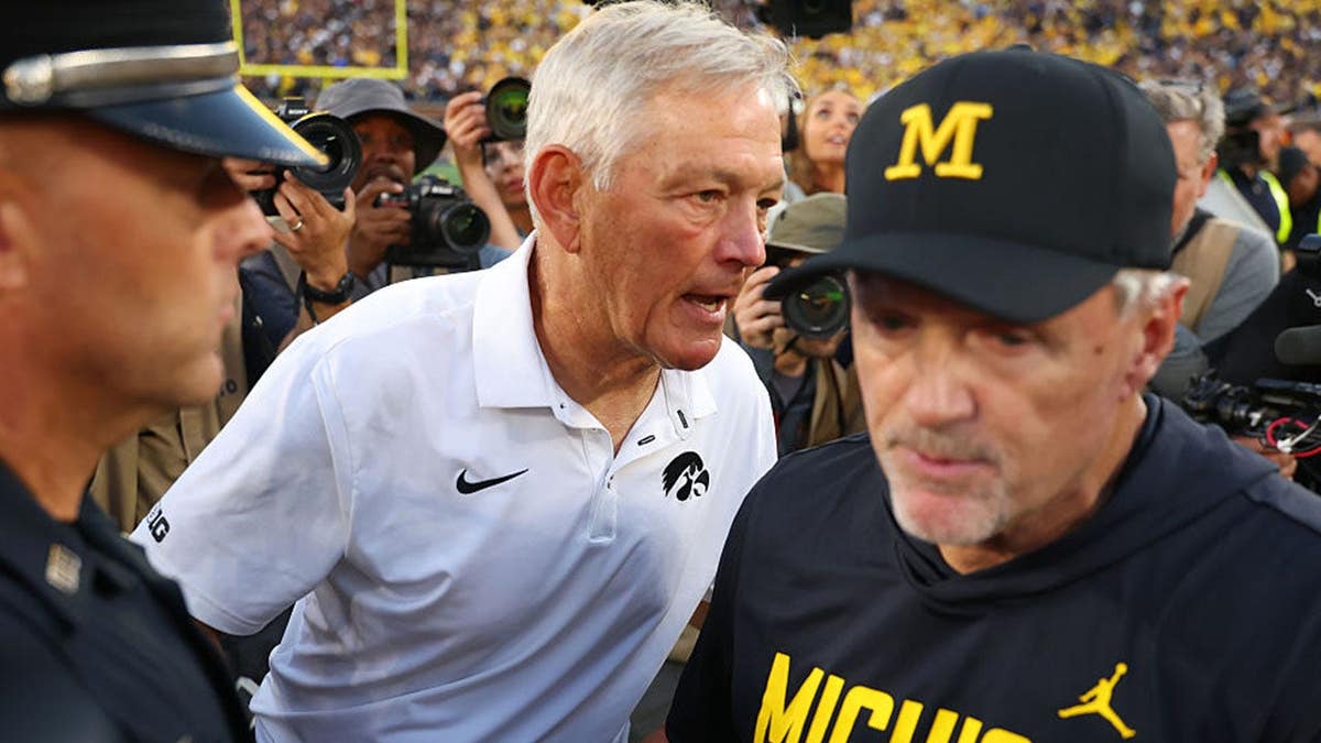 Kirk Ferentz shakes hands with Kyle Whittingham after Iowa's win at Michigan Stadium.