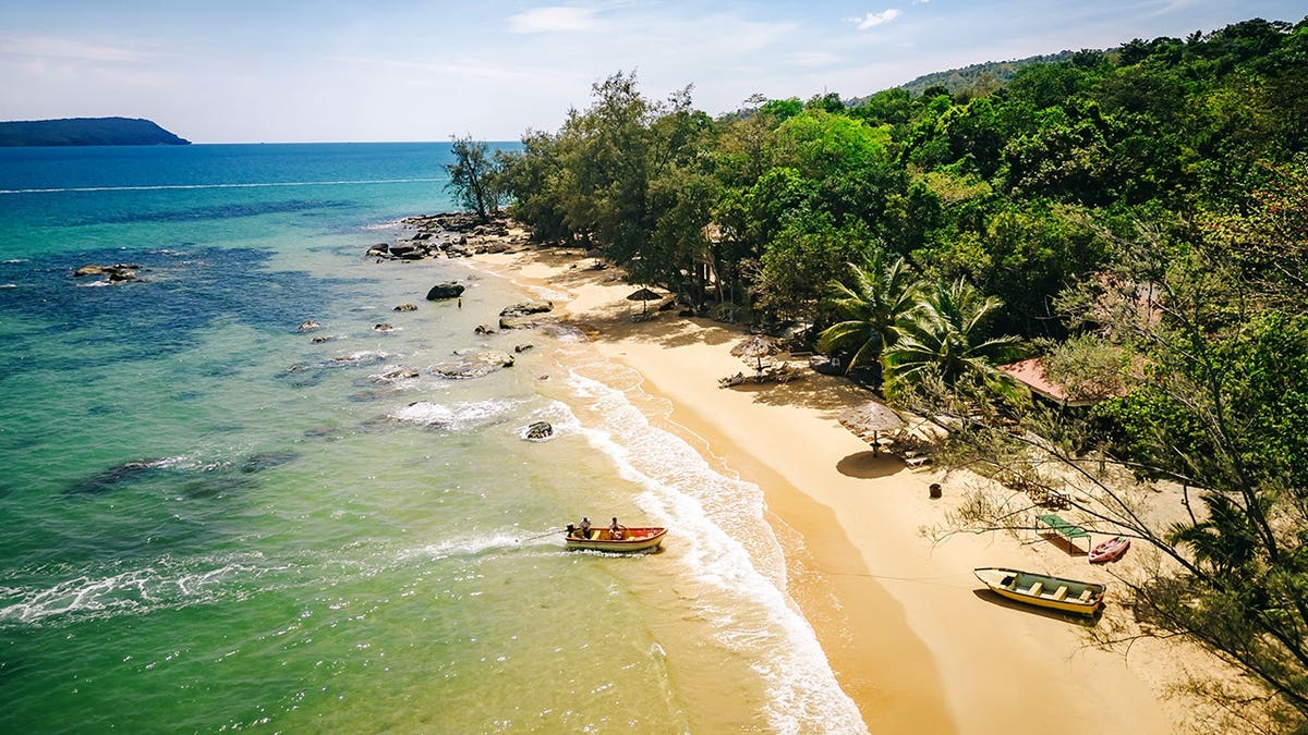 Aerial view of pristine beach on Koh Rong Island with turquoise waters and lush greenery.