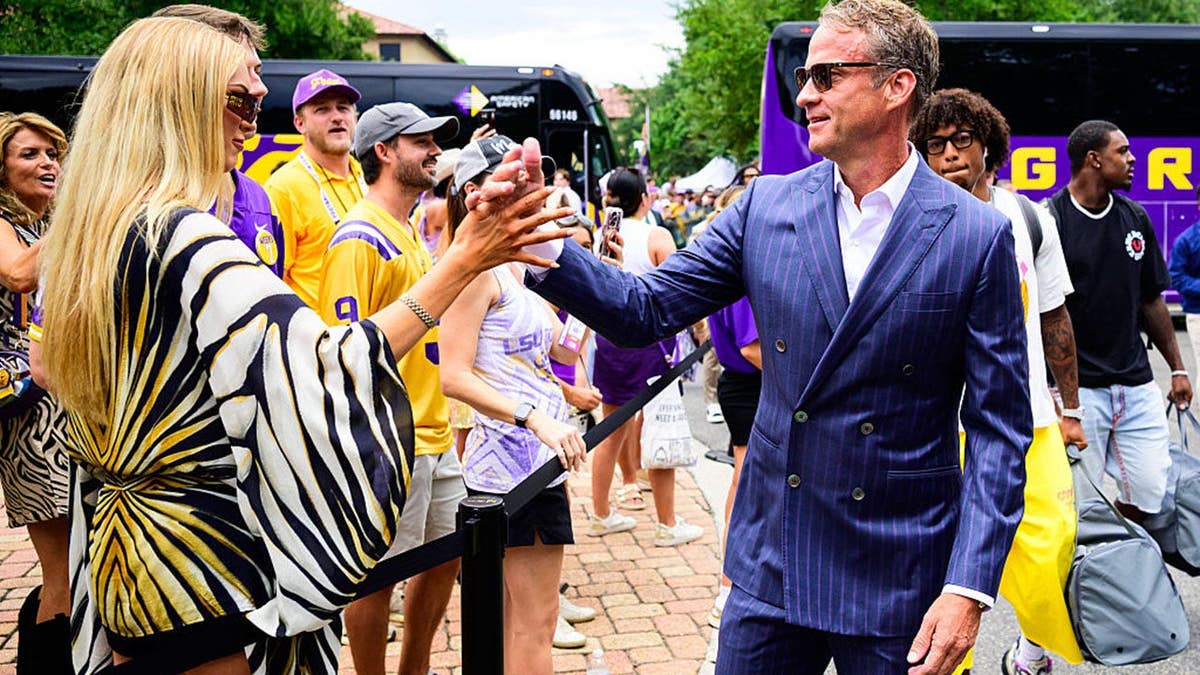 Lane Kiffin wth Landry Kiffin before a game at Tiger Stadium.