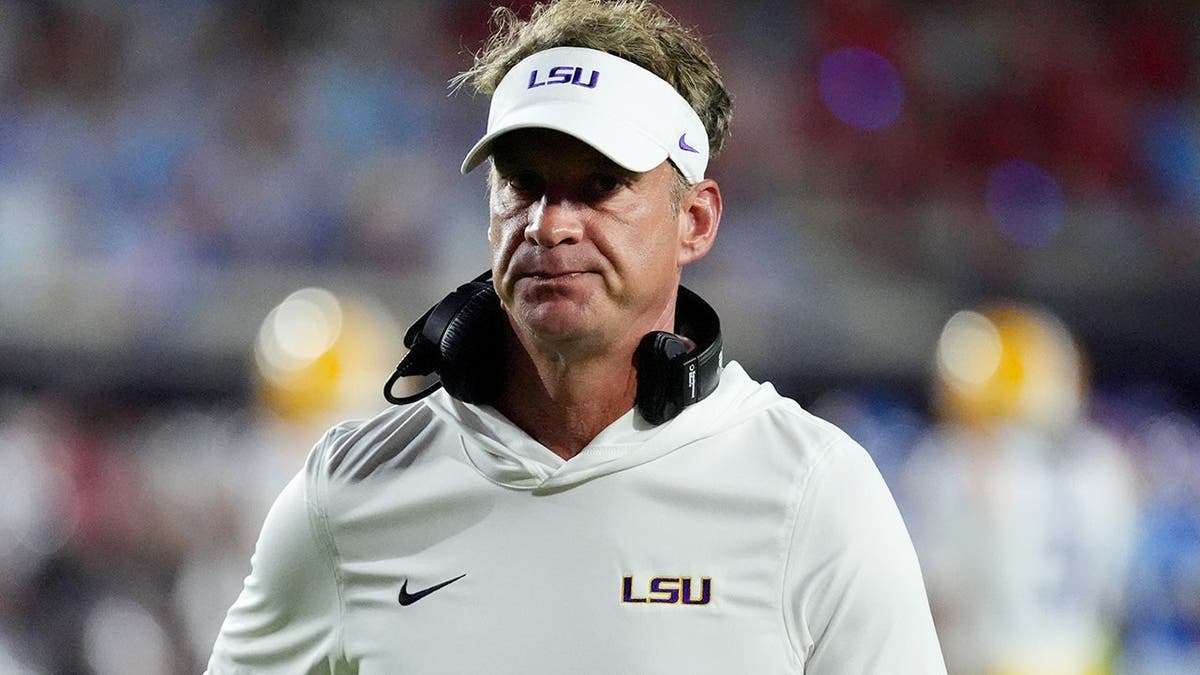 Lane Kiffin gestures toward an official during an NCAA college football game.