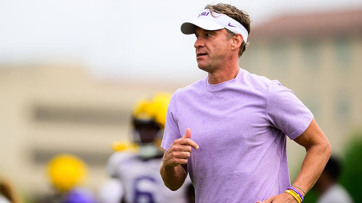 Lane Kiffin stands during LSU spring practice at the LSU Football Operations Center.