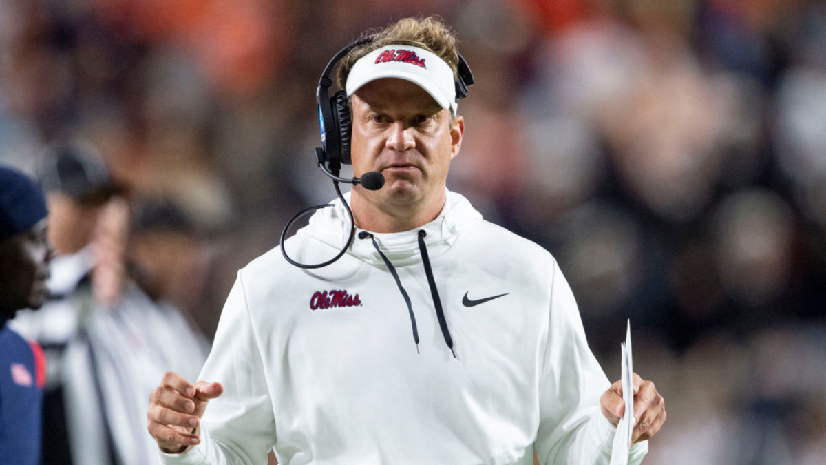 Lane Kiffin stands on the sideline during a football game.