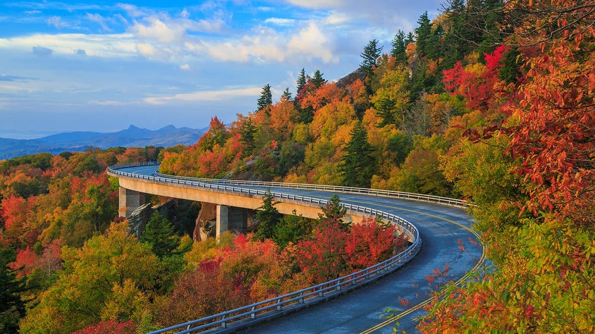 Linn Cove Viaduct winds through mountains on Blue Ridge Parkway in fall with autumn colors.