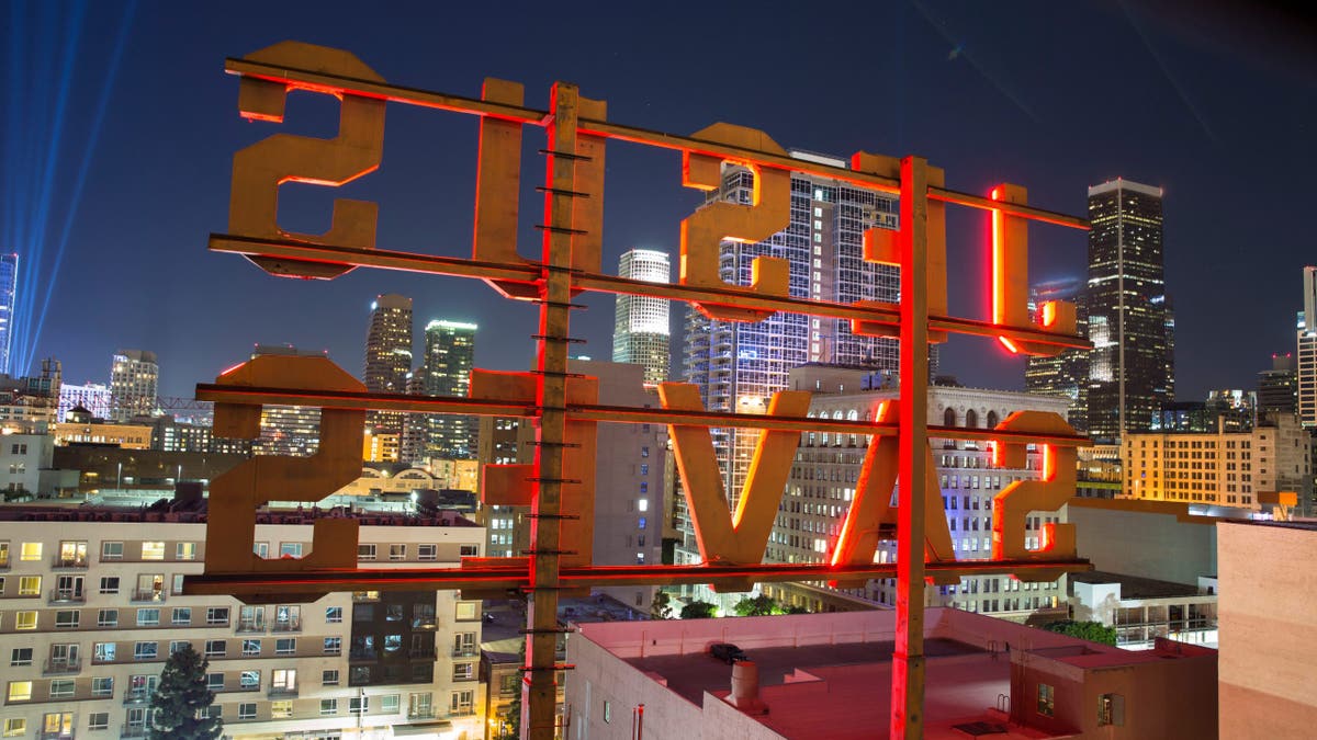 Brightly lit neon sign glows over Los Angeles.