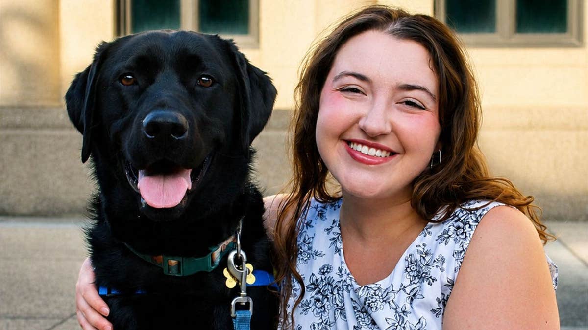LSU senior Ella Menard and her Canine Companions puppy Loyal.