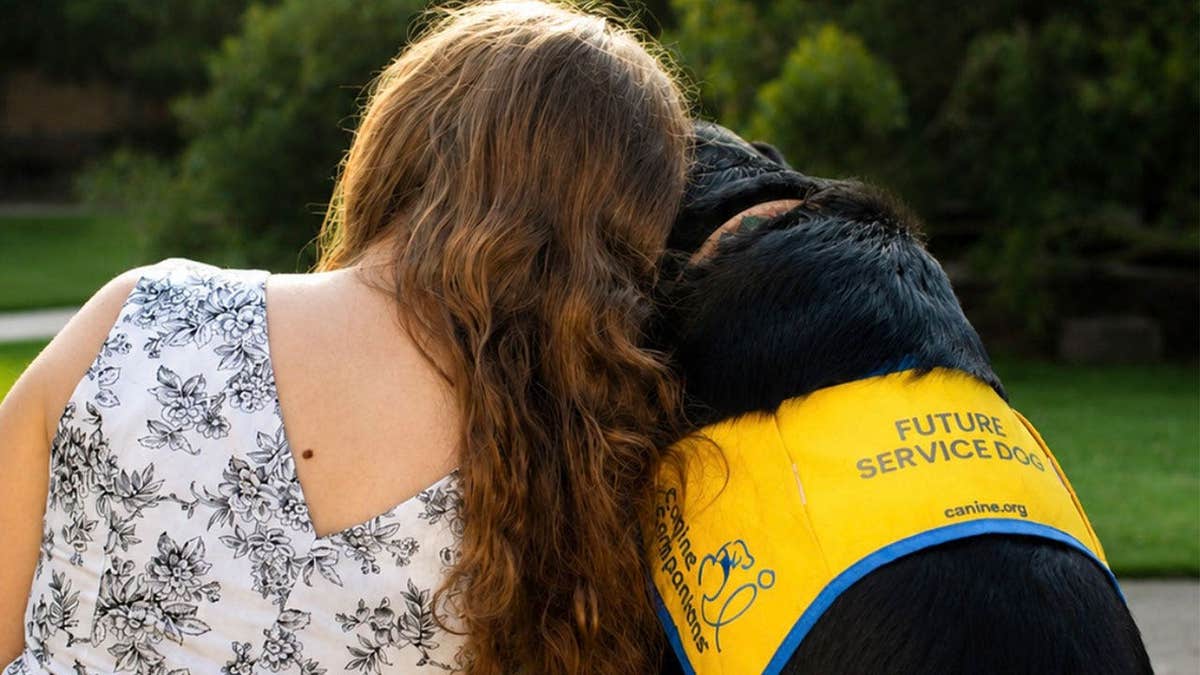 LSU senior Ella Menard and her Canine Companions puppy Loyal.