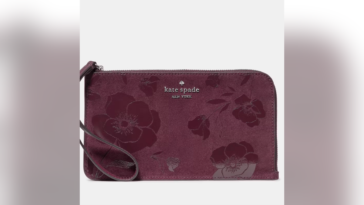 The Kate Spade Lucy Floral Suede Wristlet pairs a soft suede finish with floral detailing.