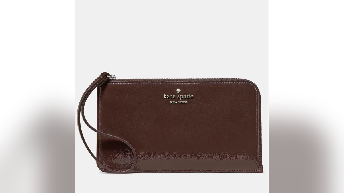 The Kate Spade Lucy Shiny Wristlet has a glossy patent finish.