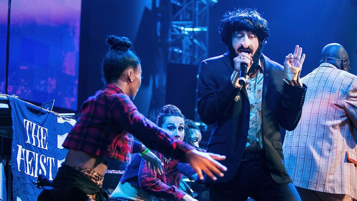 Macklemore, in costume, performs onstage at EMP Museum in Seattle.