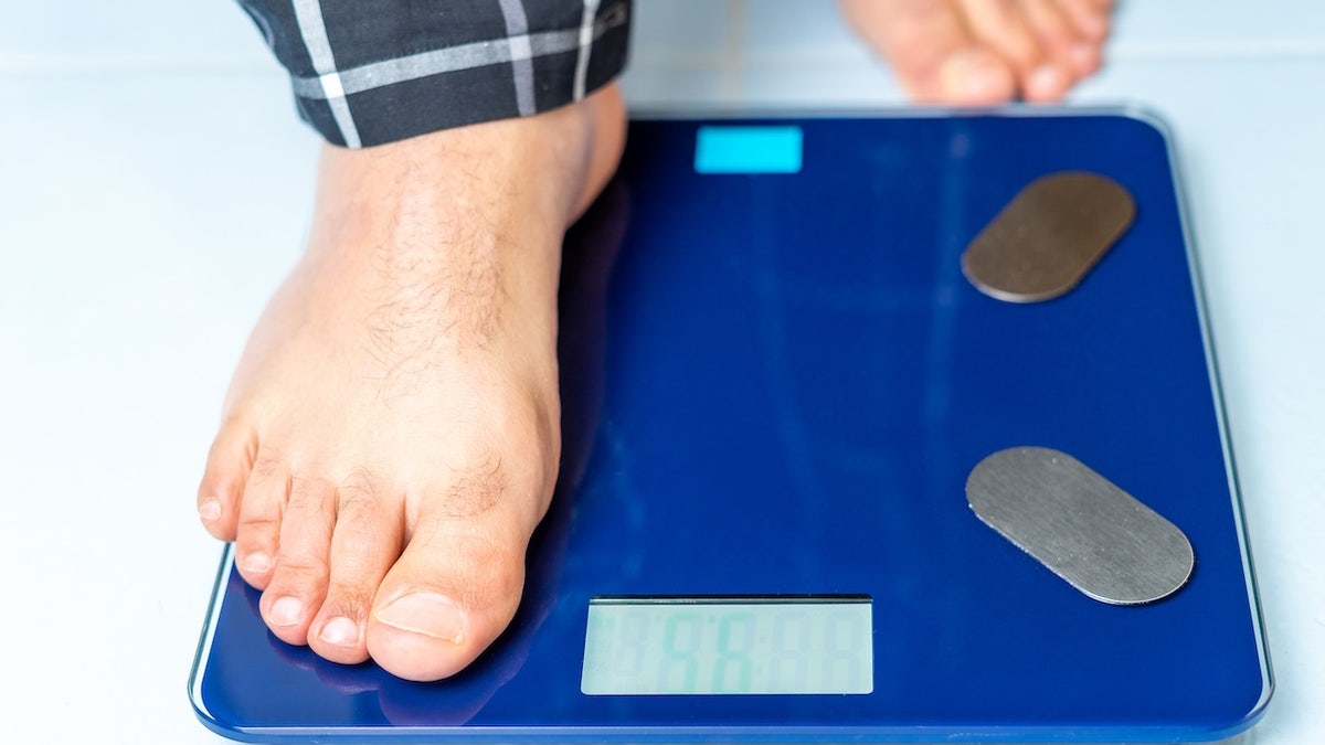 Man stepping on scale
