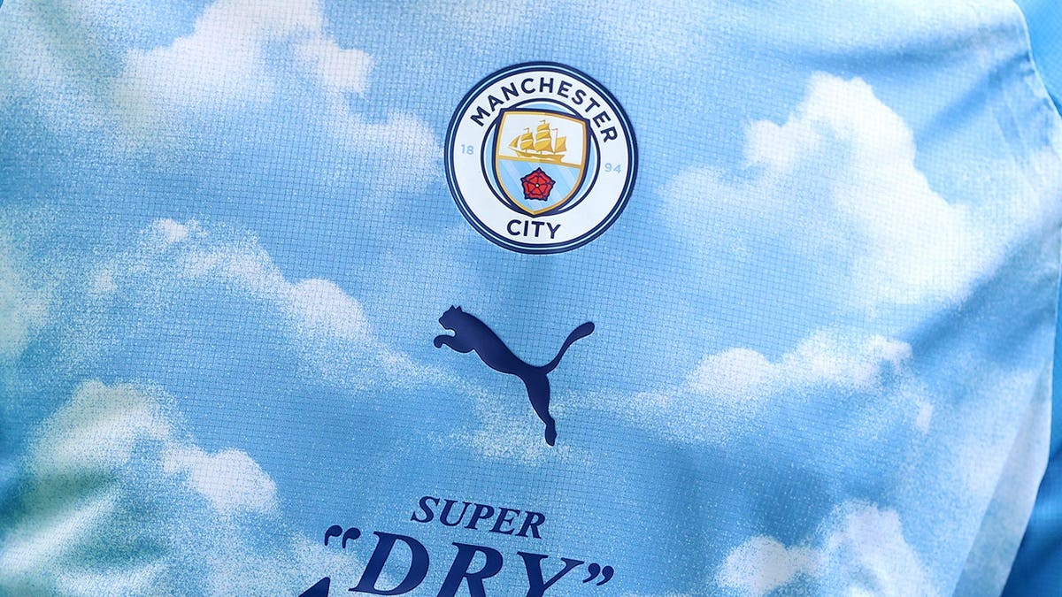Manchester City training top displaying Super Dry Asahi 0.0 sponsor logo.