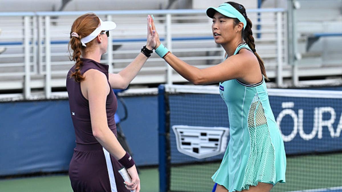 Maya Joint and Hao-Ching Chan high five during a women's doubles match.