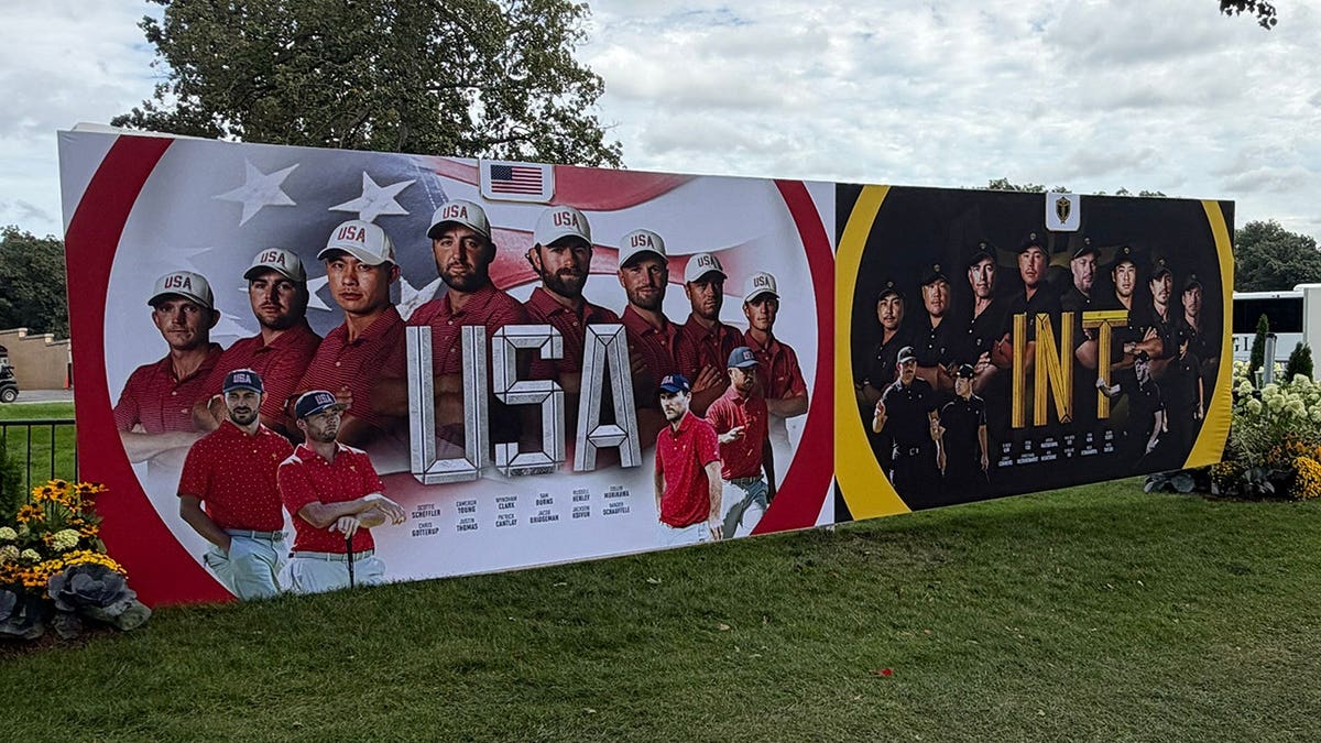 Large Presidents Cup USA and International team display on the grounds of Medinah Country Club featuring player portraits and tournament branding before the golf competition.