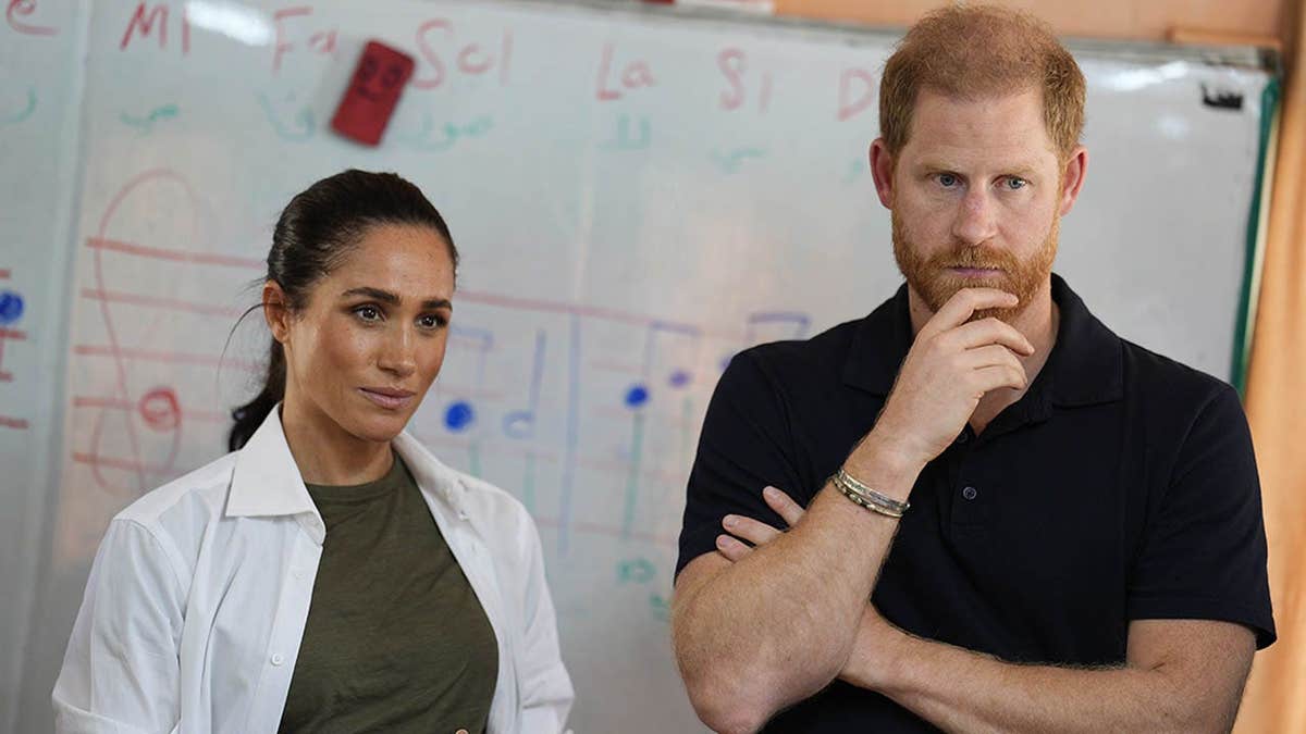 Duke and Duchess of Sussex listen during a music class at a refugee camp.