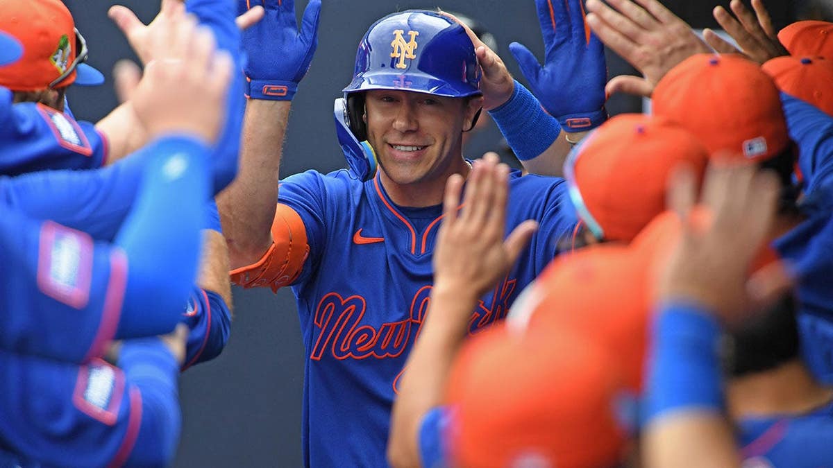 Jared Young celebrates after hitting a solo home run during a spring training game.