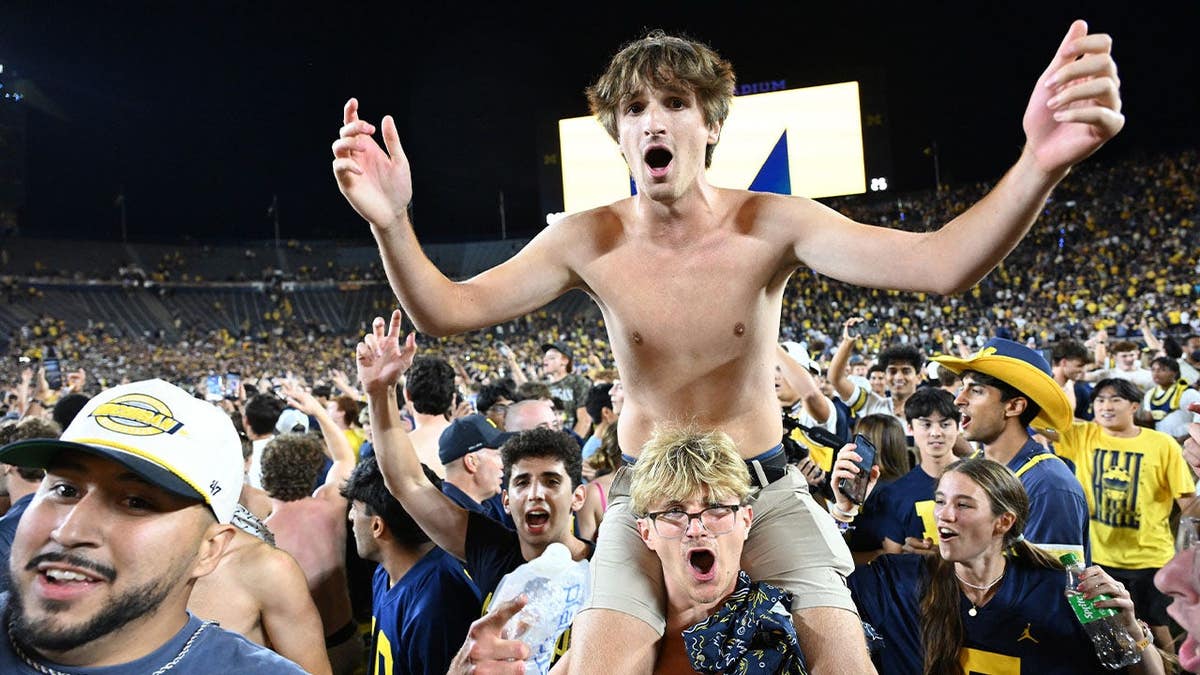 Michigan fans storm the field after Michigan beat Western Michigan