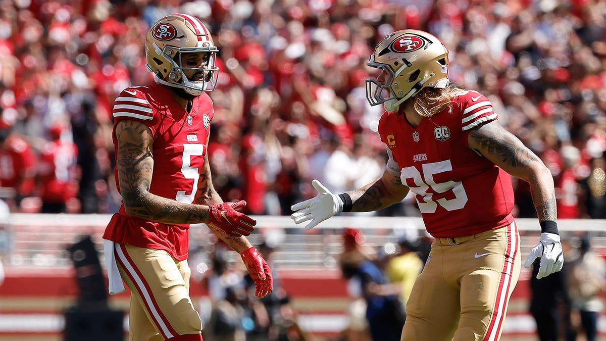 Mike Evans celebrates with George Kittle during an NFL game in Santa Clara, Calif.