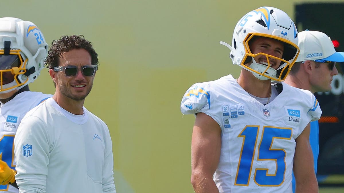 Mike McDaniel and Ladd McConkey laugh together during Los Angeles Chargers training camp.