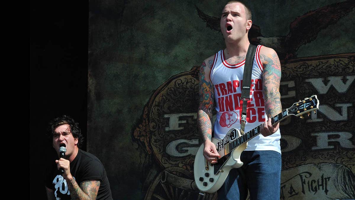 Chad Gilbert and Jordan Pundik of New Found Glory perform on stage at Reading Festival.