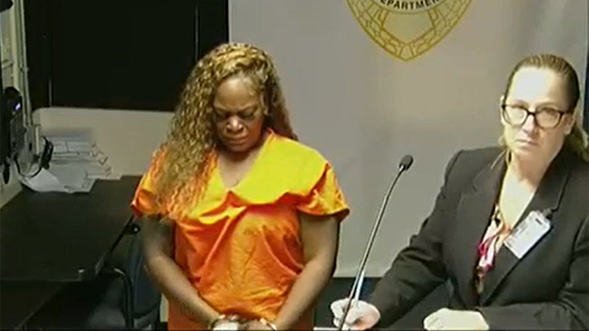 women bows her head being read a stay away order from her four kids