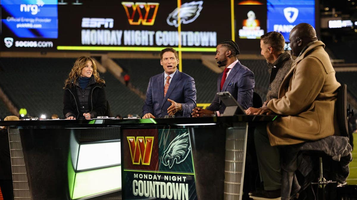 Suzy Kolber, Steve Young, Robert Griffith III, Alex Smith and Booger McFarland stand together before an NFL game.