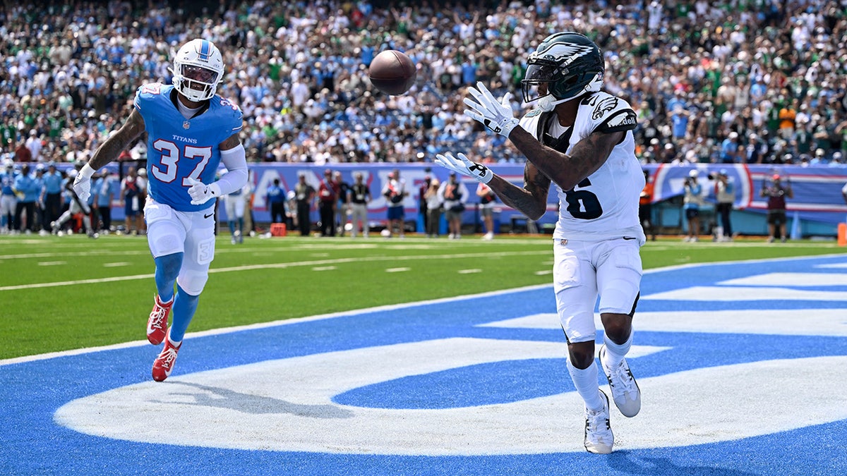 Philadelphia Eagles wide receiver DeVonta Smith (6) catches a touchdown pass ahead of Tennessee Titans safety Amani Hooker (37) during the first half of an NFL football game, Sunday, Sept. 20, 2026, in Nashville, Tenn.