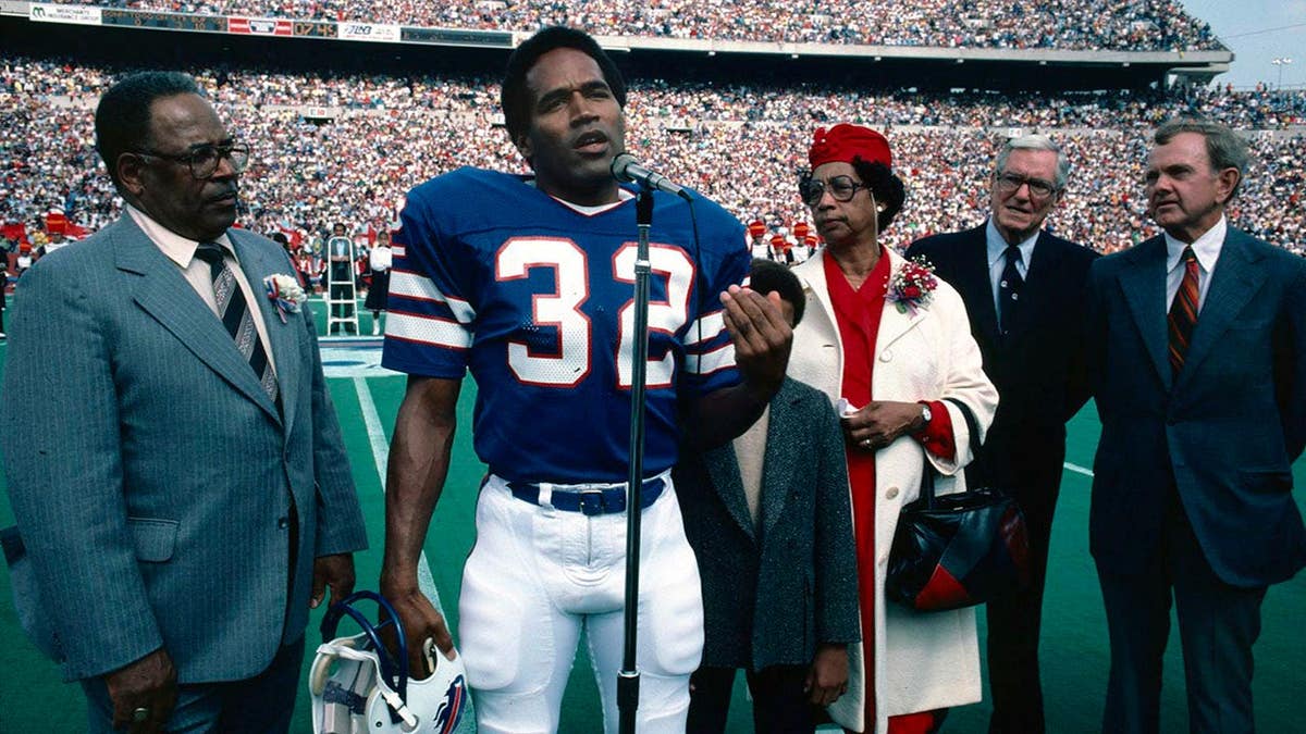 O.J. Simpson stands with family members and Ralph Wilson at Rich Stadium during Wall of Fame induction.
