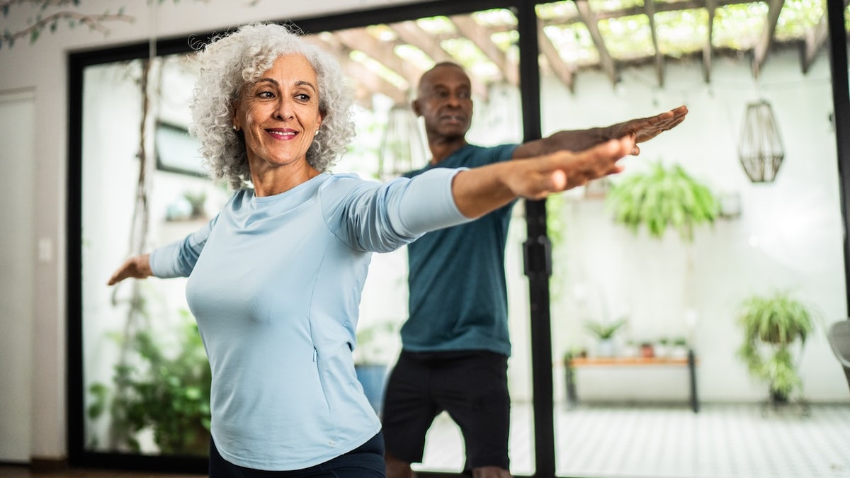 Older couple doing yoga