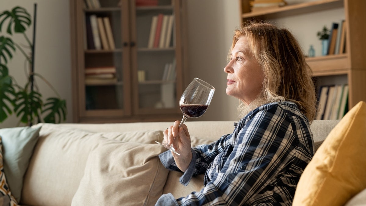 Older woman drinking wine