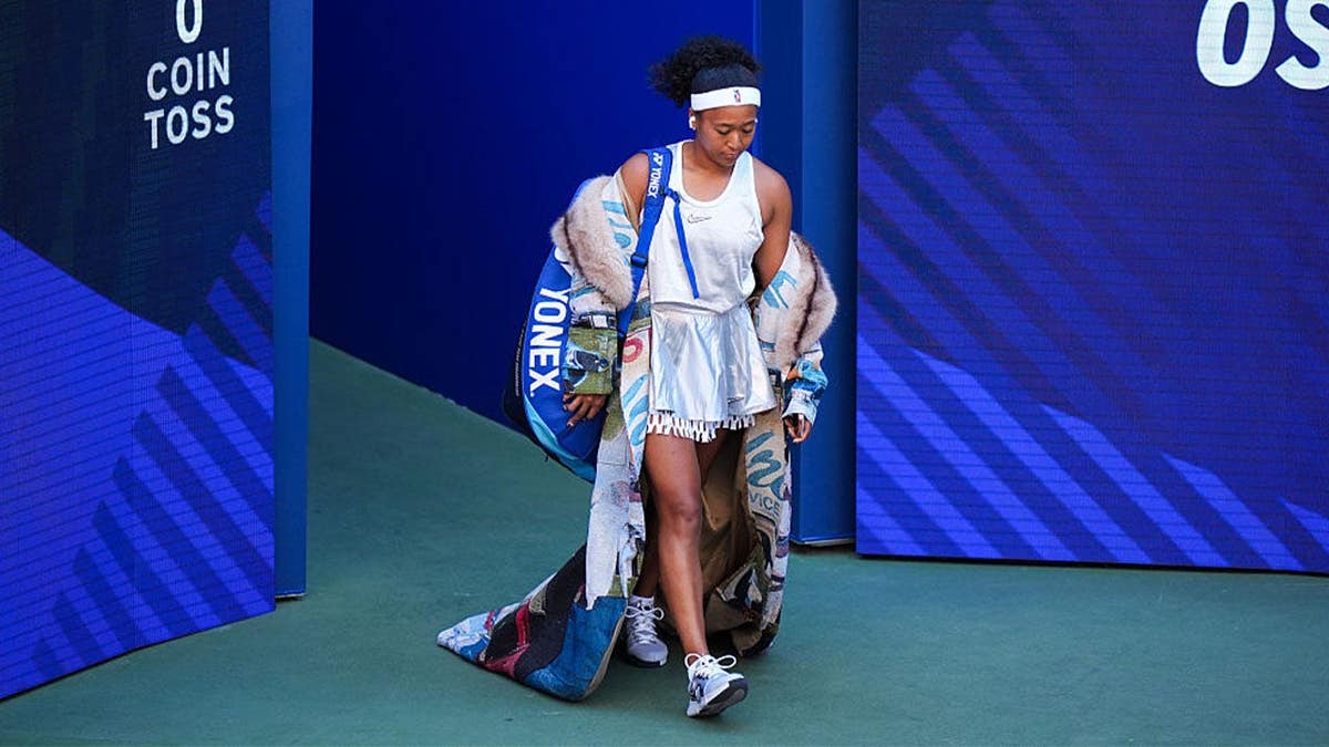 Naomi Osaka walks out on the court