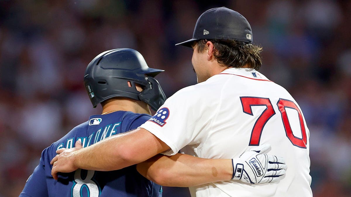 Red Sox starter records an out in hilarious fashion by hugging Mariners' baserunner  at george magazine