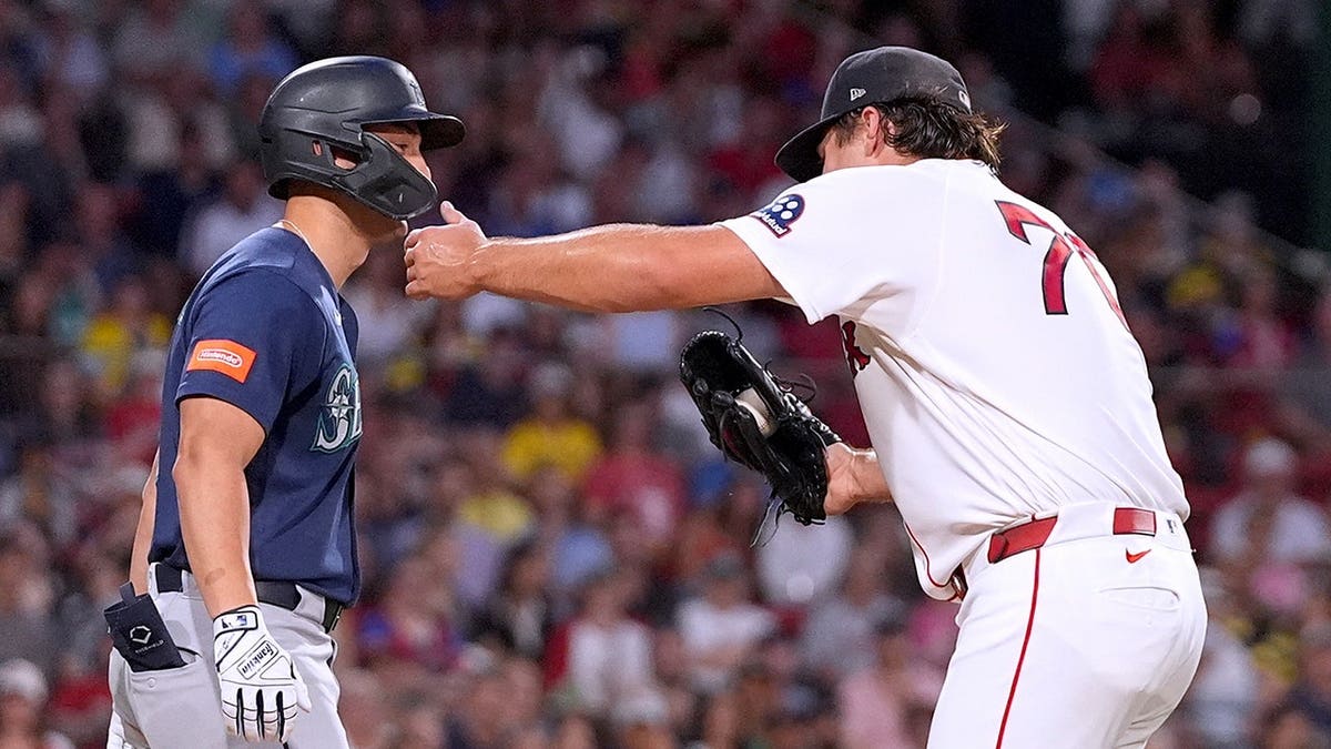 Red Sox starter records an out in hilarious fashion by hugging Mariners' baserunner  at george magazine