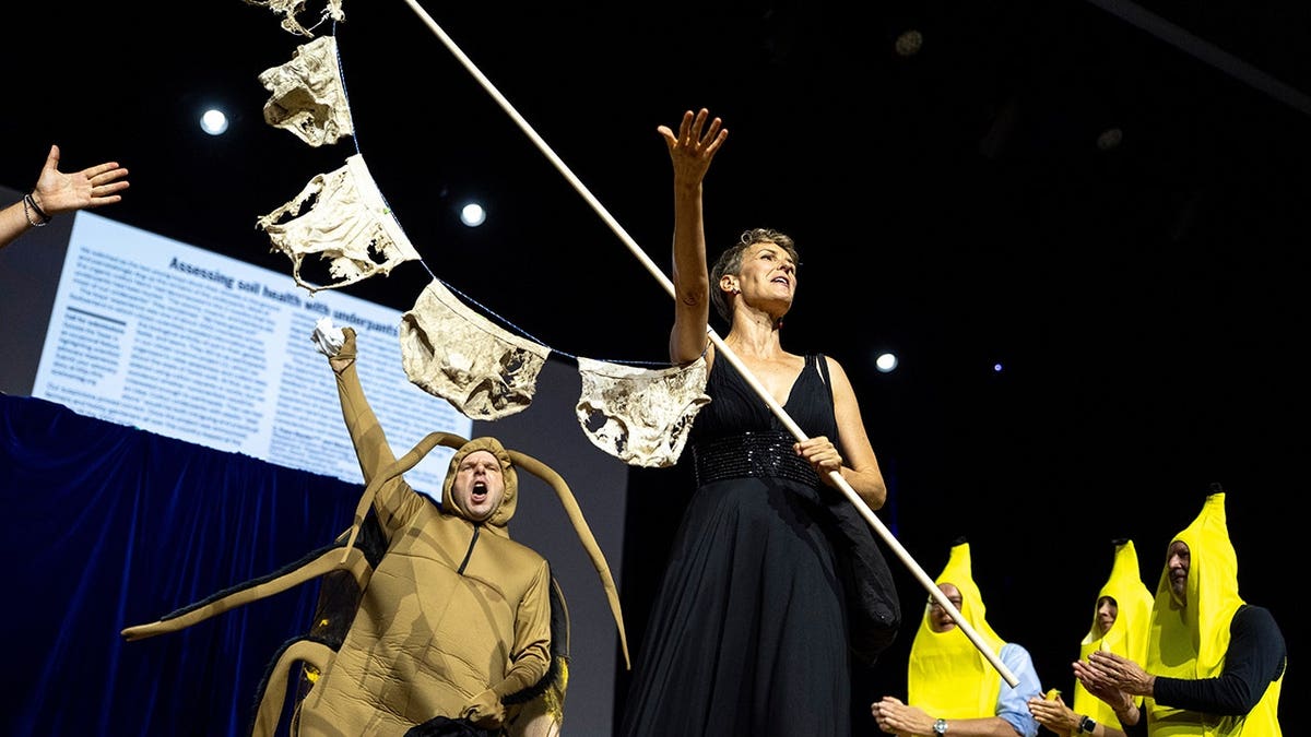 Pia Viviani and Atlant Bieri stand on stage at the Ig Nobel Prize ceremony in Zurich.
