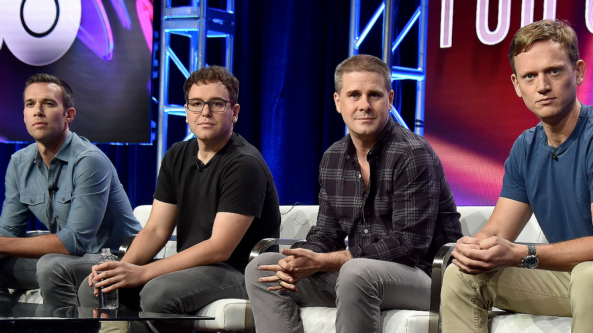 Pod Save America hosts on stage