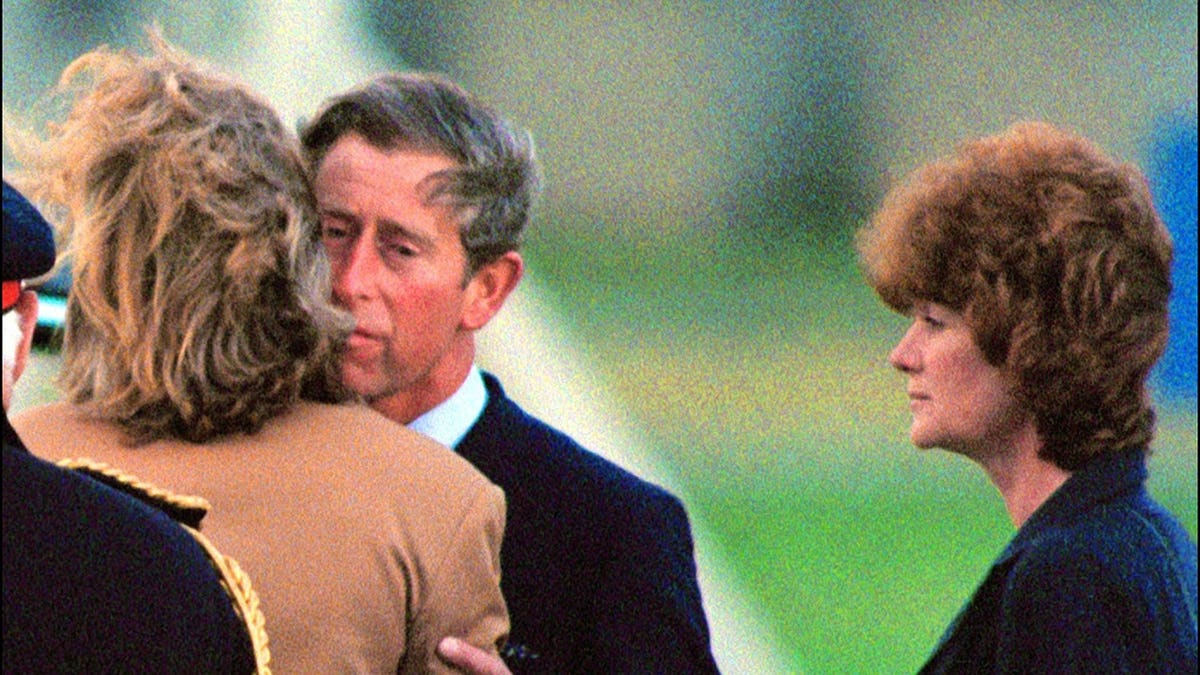Prince Charles kisses Lady Sarah McCorquodale as Lady Jane Fellows looks on.