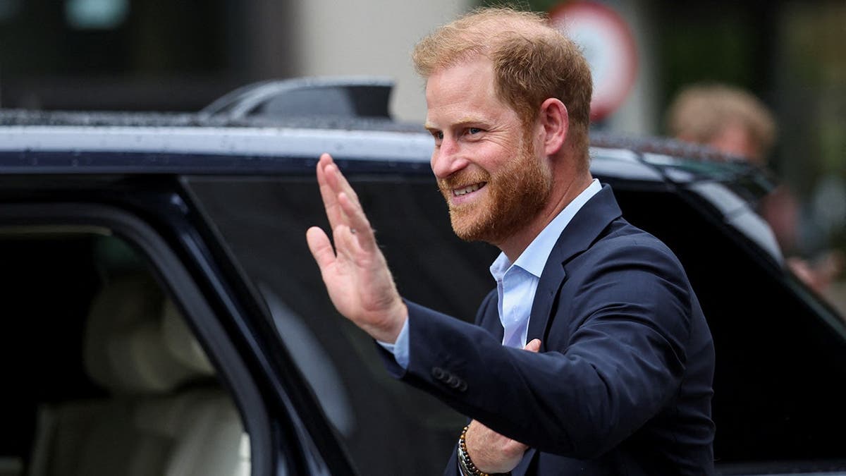 Prince Harry, Duke of Sussex, waves while departing in London.