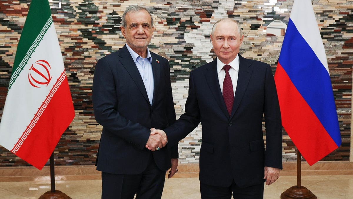 Vladimir Putin and Masoud Pezeshkian pose for a photo during their meeting in Bishkek.