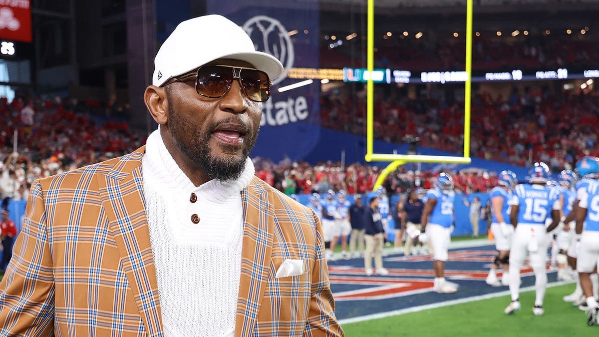 Ray Lewis, former football player, looks on during warmups prior to the game.