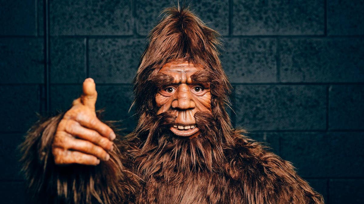 Sasquatch Bigfoot figure stands against a black background.