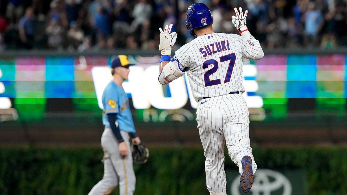 Seiya Suzuki rounds the bases after hitting a solo home run.
