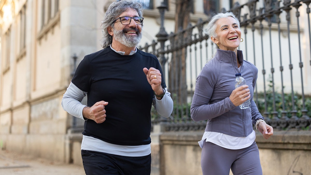 Happy senior couple jogging