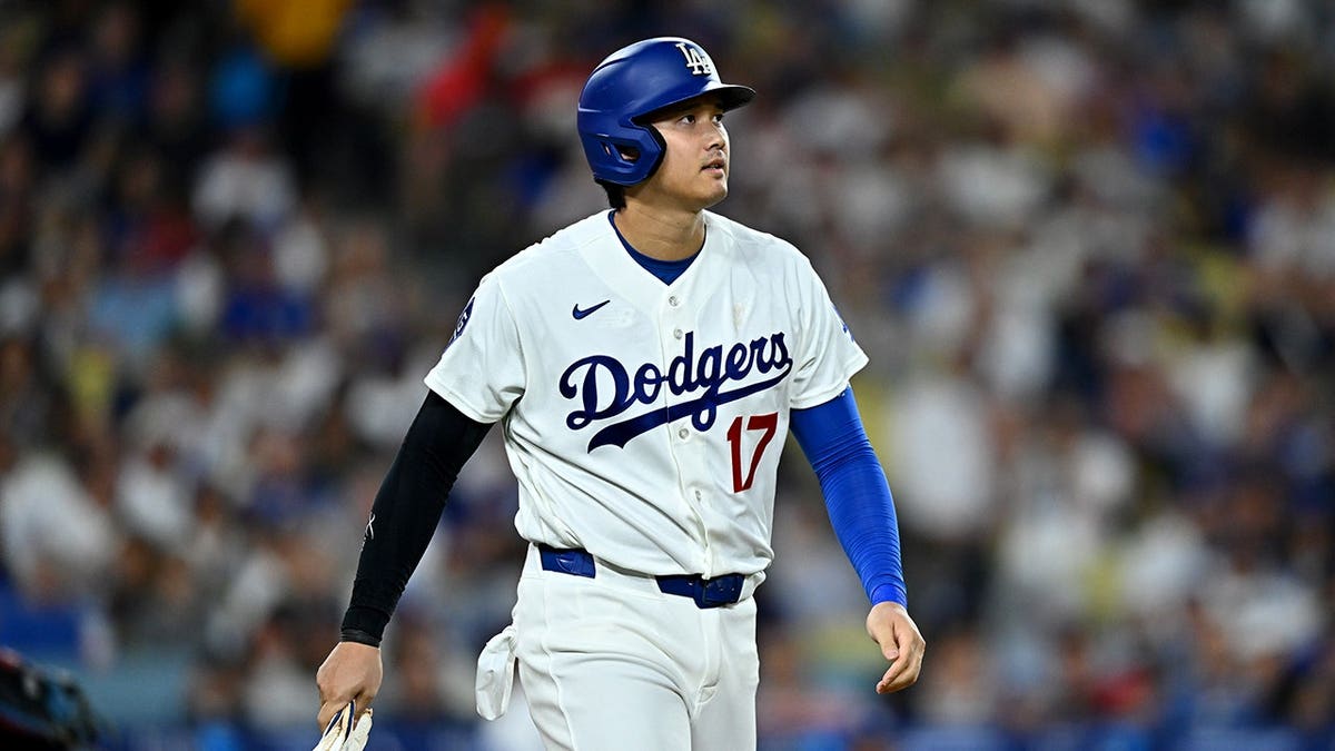 Shohei Ohtani walks to first base after being hit by a pitch.
