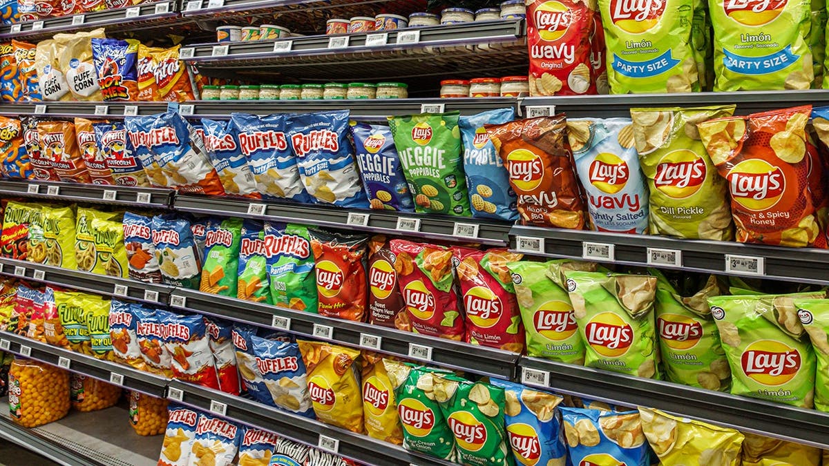 Snack aisle shelves stocked with products inside a Wal-Mart Supercenter.