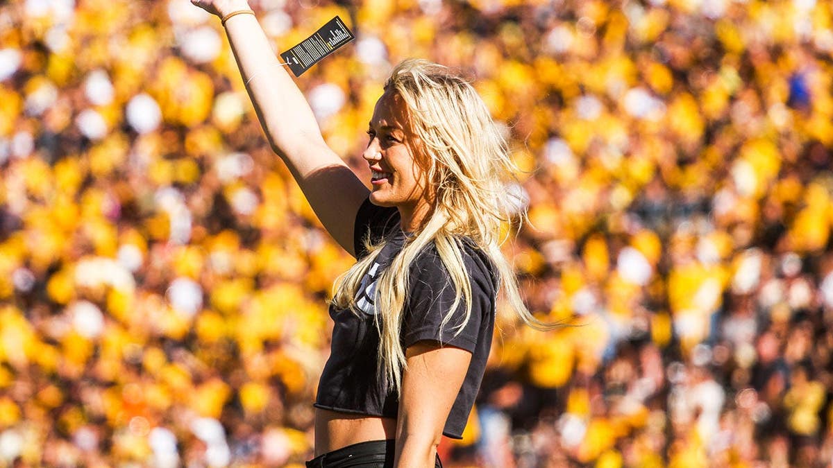 Sophie Cunningham waves to the crowd at Memorial Stadium during a college football game.