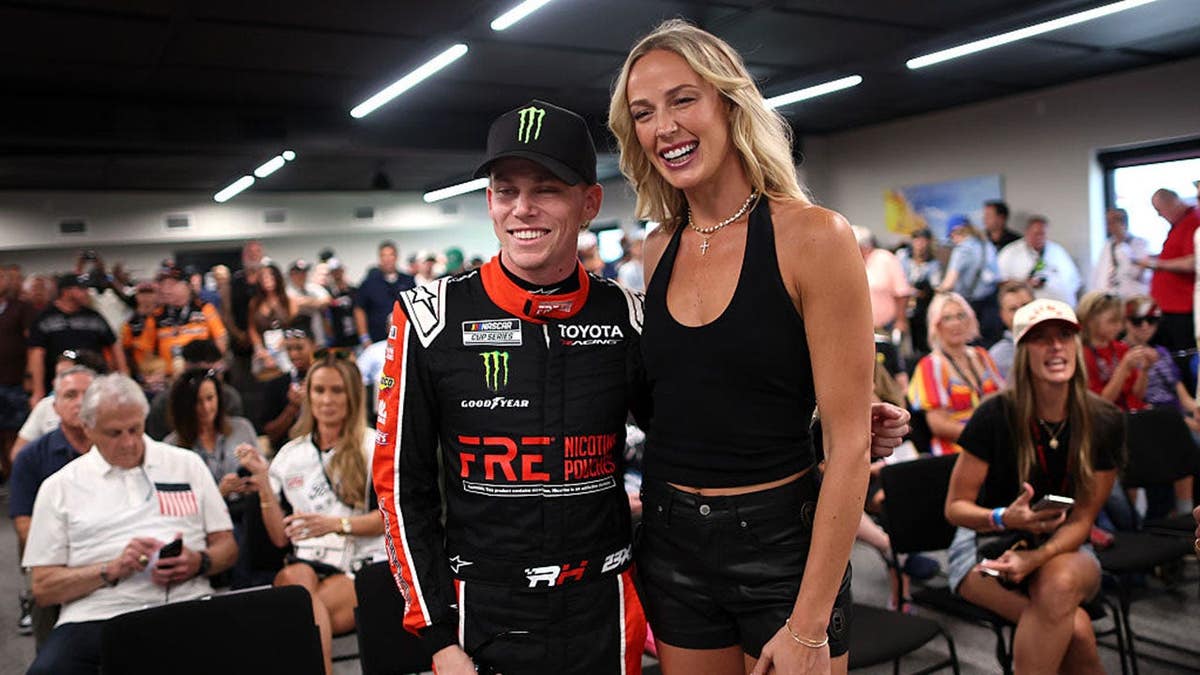 Sophie Cunningham of the Indiana Fever poses with Riley Herbst, NASCAR driver, at WWT Raceway.