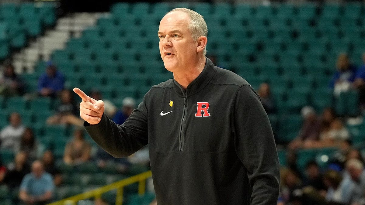 Steve Pikiell signals to his players during a college basketball game.