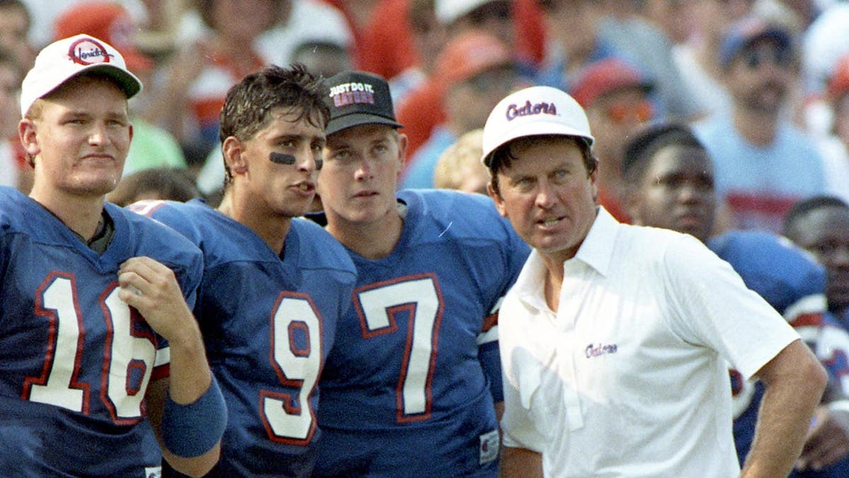 Steve Spurrier talks with his quarterbacks on the sideline in Gainesville, Fla.