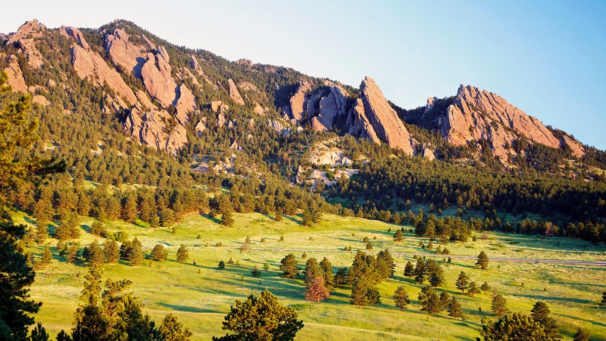 The Flatirons glow at sunrise over Boulder, Colo.