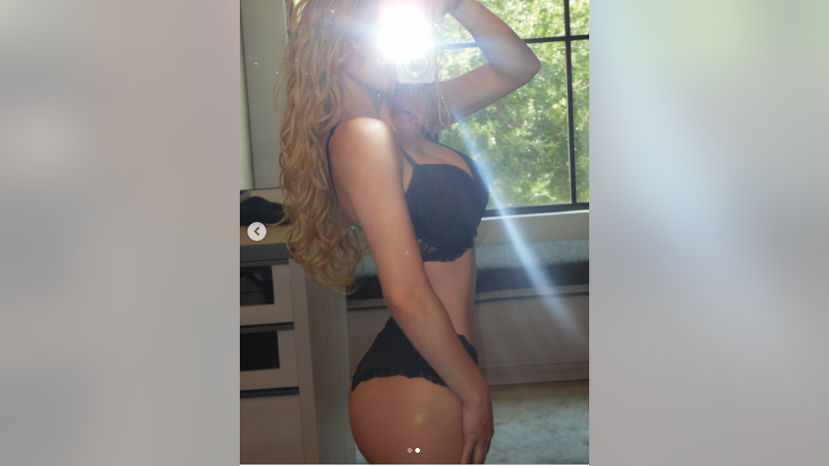 Sydney Sweeney taking a selfie in a mirror while wearing a black bra and underwear